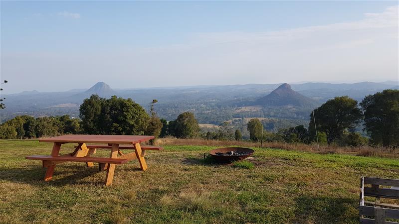 Picnic table ontop of a hill overlooking Glass House Mountains